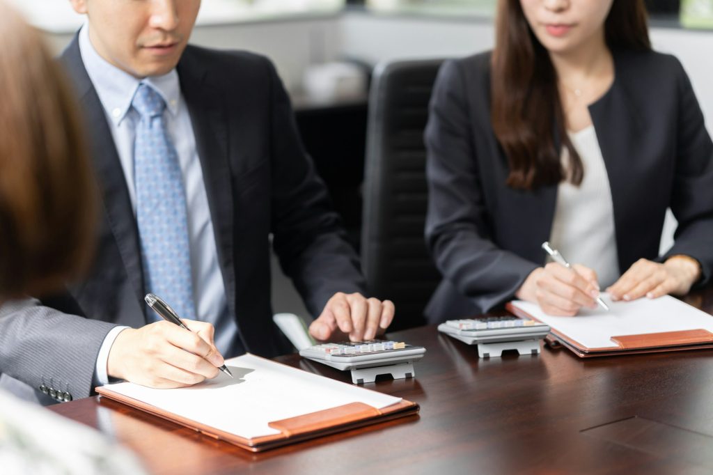 A Japanese tax accountant performs calculations after receiving tax advice.